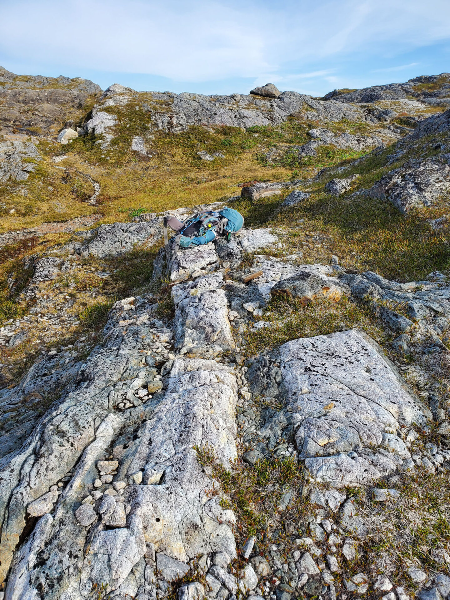 Rocky terrain with a backpack resting on it.